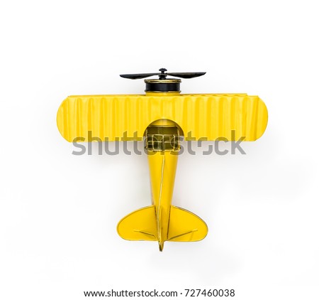 Yellow Metal toy vintage plane isolated on white for Children Fun Air Travel concept Top view Flat lay Royalty-Free Stock Photo #727460038