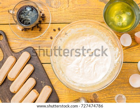 Picture of table with cookies, cups with cream