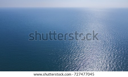Aerial view of the blue waters of the Mediterranean Sea and specifically of the Tyrrhenian Sea. Sunlight is reflected on the surface of the water. Royalty-Free Stock Photo #727477045