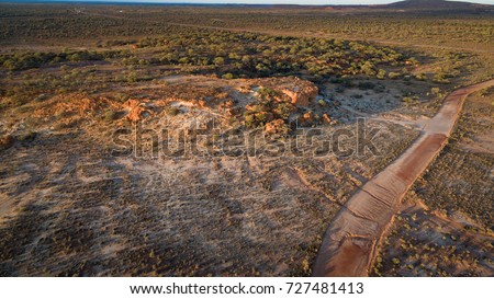 Aerial view of the red ochre and contrasting white kaolin clay cliffs in the early morning  near Mount Magnet that have been the home of the indigenous aboriginal people for thousands of years.