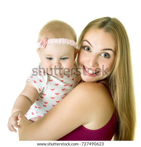 Young mother with her baby daughter happy smiling, studio portrait. Family. Adorable cute kid posing with lovely mum over white background.