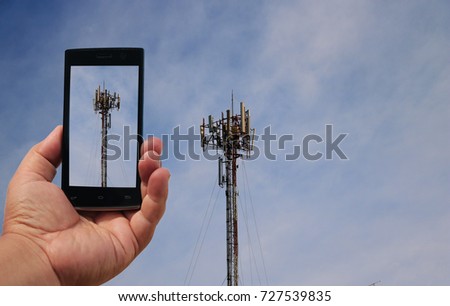  hand holding smartphone take photo at antenna on blue sky 
