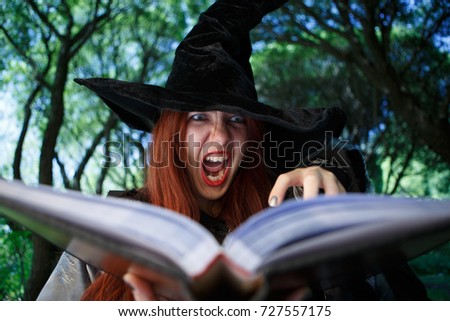 Portrait of crying witch in black hat