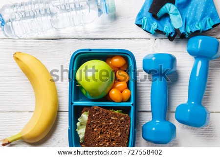 Picture of apple, sandwich, tomato in box, dumbbell