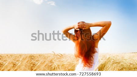 Image from back woman on wheat field