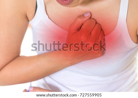 Woman's hand on chest with red spot as suffering on chest pain. Female suffer from heart attack,Lung Problems,Myocarditis, heart burn,Pneumonia or lung abscess, pulmonary embolism day
 Royalty-Free Stock Photo #727559905