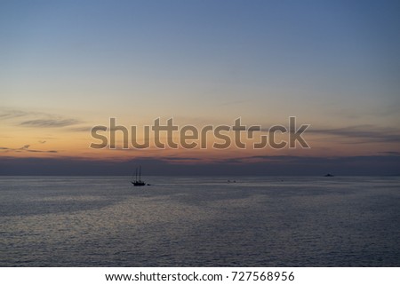 Dusk at Adriatic Sea Croatia. Beautiful nature and landscape photo of calm, peaceful autumn evening at ocean. Boats in horizon and nice color of sky. Happy and joyful outdoors image. 