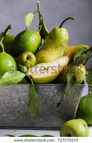 Pears and lime in  metal box. Still life