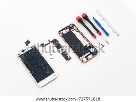 Disassembled cracked smartphone screen preparing to repair or replace new screen on white background

