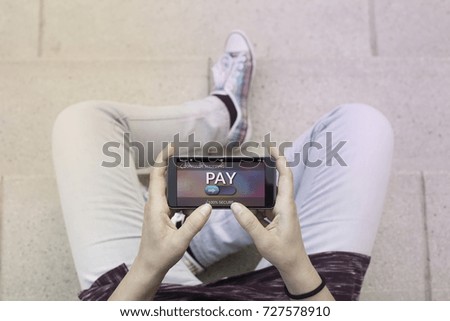 Woman using contemporary modern smartphone to make an online payment. Shopping online concept