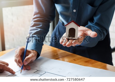 Architect or engineer using pen working on blueprint, architectural concept
