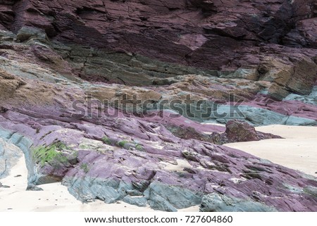 Brightly coloured rocks on a beach
