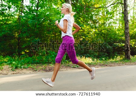Image of sports girl jogging on road