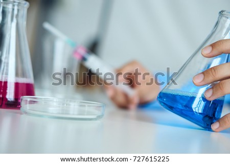 flasks, beaker, petri dish, syringe, laboratory glassware                               