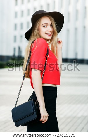 Portrait of woman in red jacket with bag