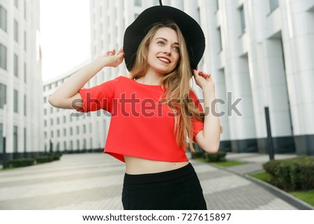 Picture of blonde in red sweatshirt and black hat