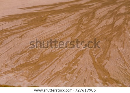 A beautiful sea sand pattern on a beach. Baltic sea shore sand texture. A beautiful sandy pattern for background.