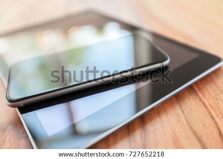 digital tablet and smart phone on wooden table