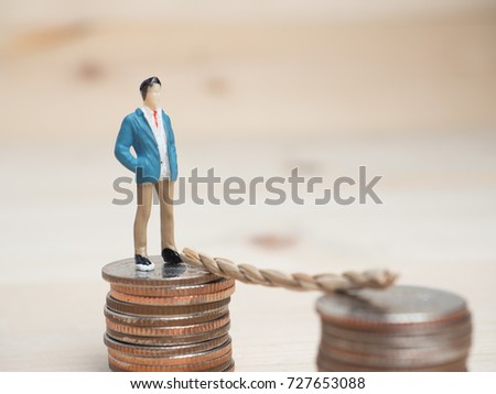 Money and Business Concept. Businessman small figure standing .
