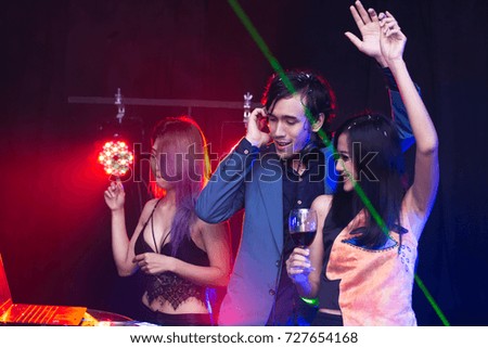 Group of young Asian People have a Party Together in Nightcub.  People Dancing with Attractives Smiling. People with Party Concept.