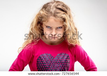 Portrait of preteen sulky girl making angry face against plain background Royalty-Free Stock Photo #727656544