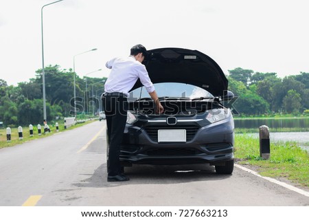 Car trouble, Broken car,Businessmen have problems with the car and Trying to solve. (selective focus,out of focus) Royalty-Free Stock Photo #727663213
