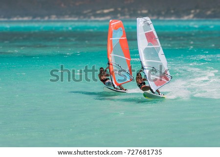 Couple windsurfers in the lagoon of Emerald Sea, Antsiranana bay (Diego Suarez), Madagascar. Royalty-Free Stock Photo #727681735