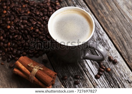  coffee cup with coffee beans on wood background