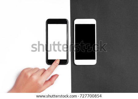 Top view of a woman hand using phone. Black and white phone and backround 