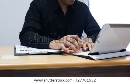 businessman working with business documents on office table with digital tablet computer and graph finance diagram in the background