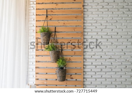 Brown wooden glass window with flowers inside on the white facade