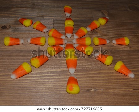 Bright photo of candy corn in the shape of a snow flake 