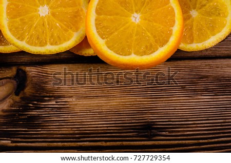 Slices of the orange on wooden table. Top view