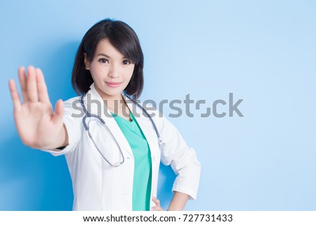 beauty woman doctor show stop to you on the blue background