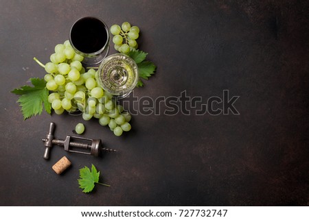 Wine glasses and grapes on stone table. Top view with space for your text
