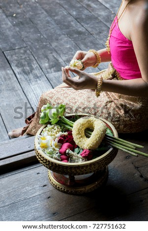 thai woman doing make jasmine garlands for any special occasion ceremony in buddha