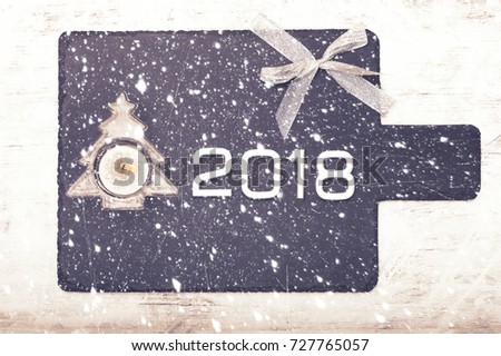 Black slate board for serving with copy space, Happy new year 2018 text, Holiday abstract glitter background and falling snowflakes, Vintage design, Blurred Abstract, Toned photo