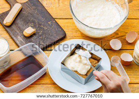 Photo of cooking tiramisu from cookies, cream cheese, coffee, confectionery