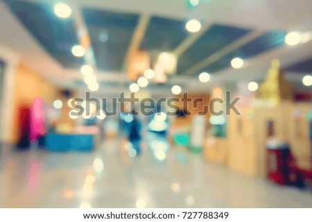 Blurred image of people in shopping mall with bokeh.