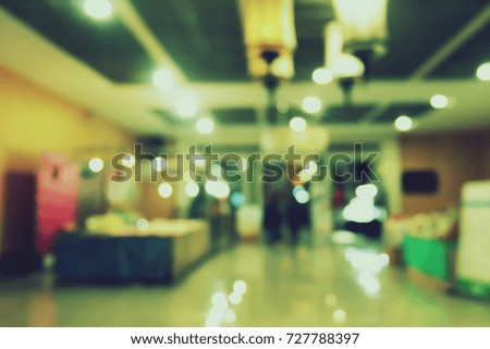 Blurred image of people in shopping mall with bokeh.