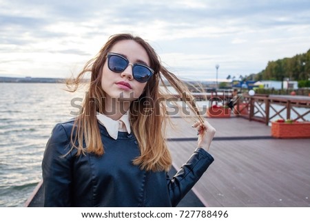 Caucasian young girl with eyeglasses by the sea