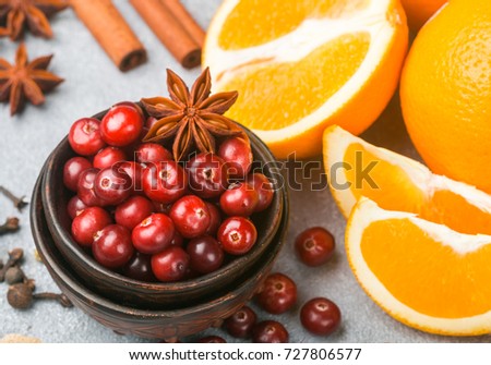 Ingredients for cooking traditional spicy winter drinks - cranberry, citrus, cinnamon, cardamom, star anise, cloves, pepper. Non-alcoholic mulled wine. Punch. The compote. Morse