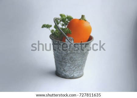 pepper and a sprig of parsley in a little bucket