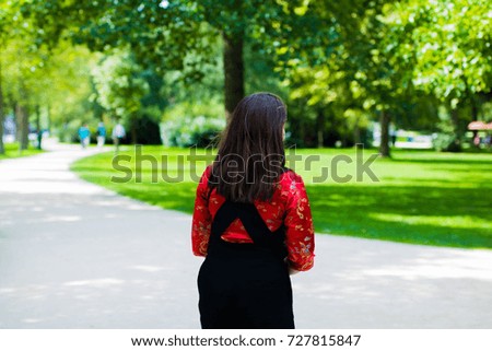 Young woman in urban area in red outfit