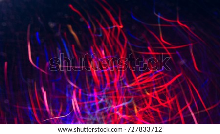 Abstract picture of colorful lines in motion on black background. Bokeh of defocused curves, blurred neon blue and red leds of serpentine, festive backdrop of fireworks, holidays and celebrations
