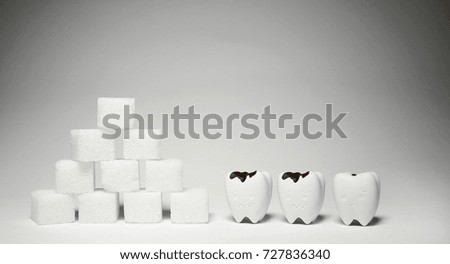 Decayed Teeth Model in bad and sad feeling look at Heap of a lot of cubes sugar warning Dental Healthy 2