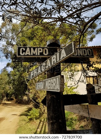 City arrow board, on dirt road, in the interior of Minas Gerais state, Brazil.