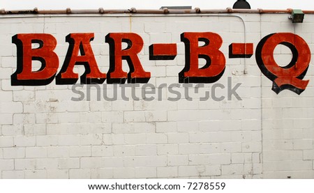 A Bar-B-Q sign on the side of a building