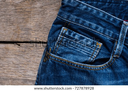 jeans denim pile stacked on wood background