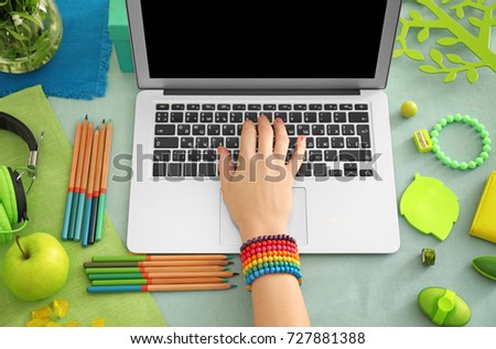 Woman working with laptop at table